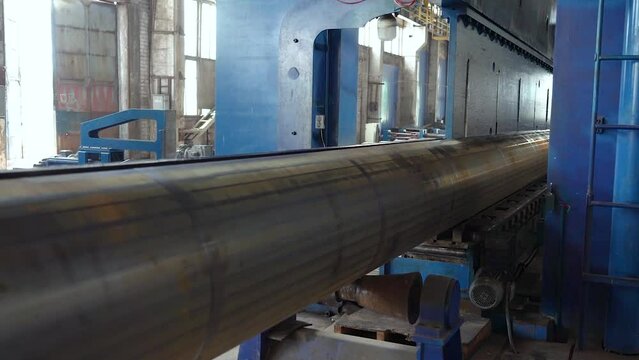 Pipe manufacturing plant. Pipe plant. Iron pipe welding. Pipe expansion. Sparks of welding. Tap. Factory. Machine tools. Production. Heavy industry.