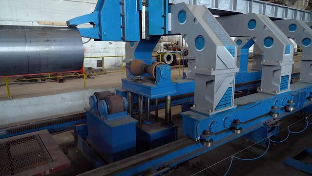 Pipe manufacturing plant. Pipe plant. Iron pipe welding. Pipe expansion. Sparks of welding. Tap. Factory. Machine tools. Production. Heavy industry.