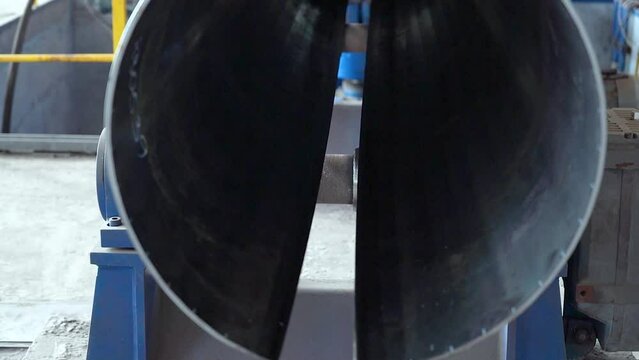 Pipe manufacturing plant. Pipe plant. Iron pipe welding. Pipe expansion. Sparks of welding. Tap. Factory. Machine tools. Production. Heavy industry.