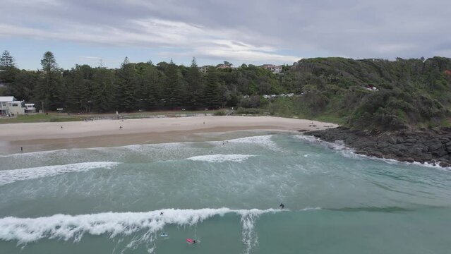 Surfers In Flynns Beach On A Cloudy Day In Port Macquarie, Australia - Aerial Drone Shot