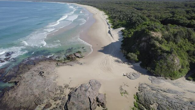 Ocean Waves Splashing On The Beach In Wenonah Head, Urunga, Australia - drone shot