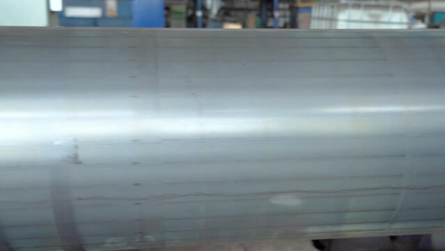 Pipe manufacturing plant. Pipe plant. Iron pipe welding. Pipe expansion. Sparks of welding. Tap. Factory. Machine tools. Production. Heavy industry.