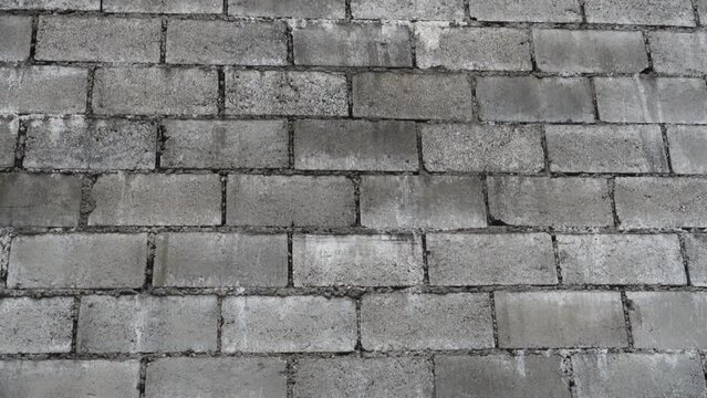 A grey concrete masonry Unit, CMU textured wall in India. Interiors and decoration.