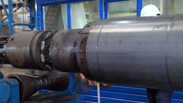 Pipe manufacturing plant. Pipe plant. Iron pipe welding. Pipe expansion. Sparks of welding. Tap. Factory. Machine tools. Production. Heavy industry.