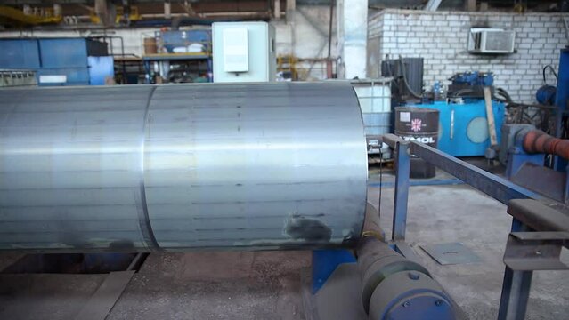Pipe manufacturing plant. Tube plant. Iron pipe welding. Pipe expansion.  Tap. Factory. Machine tools. Production. Heavy industry.