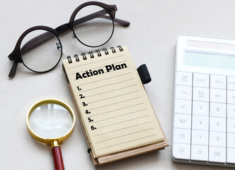 Action plan word in notebook, top view