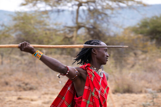 Maasai tribesman throwing a spear and hunting