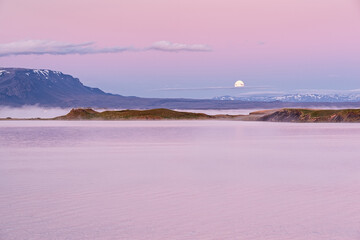 Sunrise in Myvatn lake with fog and moon during the summer season, Iceland