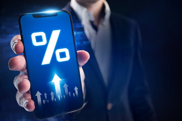 Interest rate and dividend concept. Businessman uses a mobile app to monitor interest rates