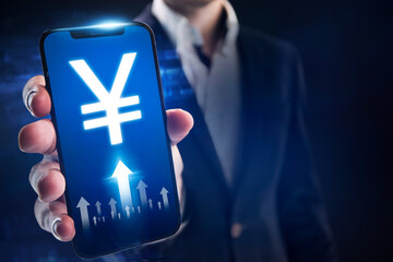 Yuan growth concept. Businessman follows the growth of the dollar through a mobile app