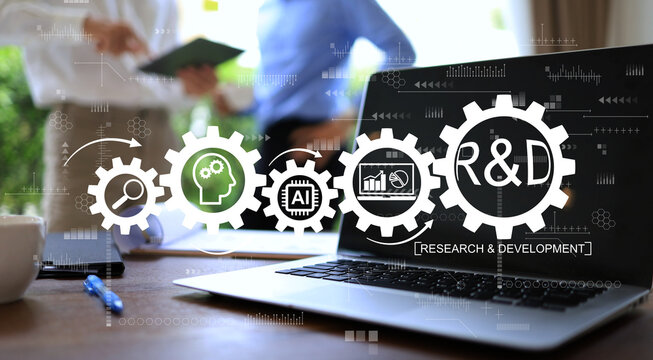 R and D  research development process icon with laptop screen on working desktop background discusstion between team staff.