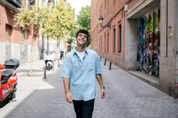 Young man with curly hair in the city