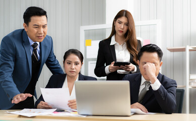 Business mentor meeting with team in office looking at computer screen training management concept. Asian businessman work together with executive colleague group talking mentoring leadership idea.