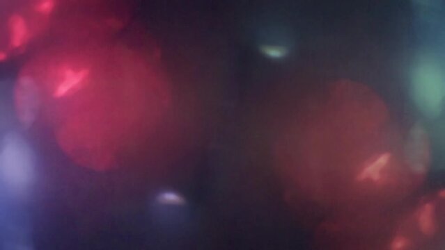 Abstract particles and flares footage, Colorful flares, emergency lights on black background 4k footage.