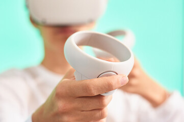 Selective blur. Close-up of a virtual reality controller or vr joystick held by the hand of a young...