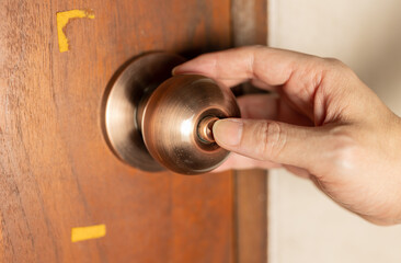 Obraz premium Close up of a hand pressing a door lock, Concept of safety.