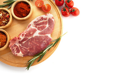 Fototapeta premium fresh meat steak on a wooden board with spices and rosemary on a white background and free space for text