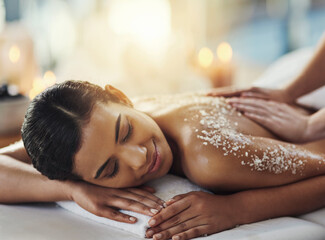 Happy woman, salt scrub and massage back at spa to relax for skincare, exfoliation or self care....