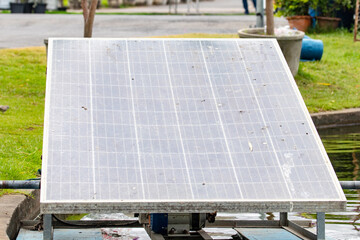 Old solar panel used to generate electricity for wastewater treatment dirty outside caused by falling branches in park. To be used as renewable energy and clean energy. natural renewable energy.