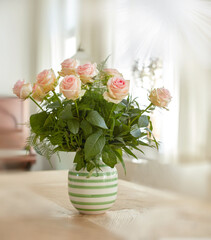 Closeup of bouquet of pink roses in a vase, nature and flowers on living room table, gift for romance or friendship. Plant, botanical and symbol of love, natural and floral arrangement at home