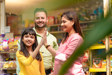 Happy Indian family at grocery shop.