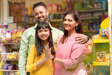 Happy Indian family at grocery shop.