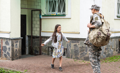 Happy little girl having fun with her military father