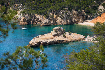 People sunbathe on Galley rock or Submarine rock. View  from hiking path near Calanque de Port...