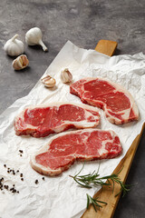 Filet mignon on tabletop on rocky background(Rosemary, garlic, butter, pepper, salt and other spices),close up