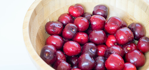 Close up of cherries in a bamboo bowl