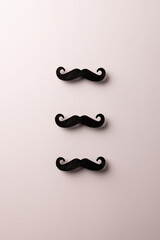 Composition of fake moustaches on white background