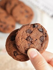 Cocoa brownies sprinkled with cocoa powder on a white tabletop