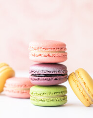 Colorful macaron cakes with cream filling on a table indoors, close-up