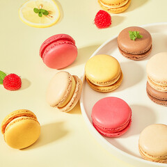 Colorful macaron cakes with cream filling on a table indoors, close-up