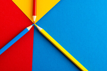 Close up of red, yellow and blue pencils with copy space on red, yellow and blue background