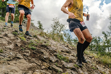 group athletes runners running down steep mountainside, summer trail marathon race © sports photos