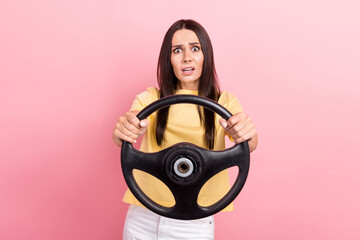 Photo of stupor confused woman dressed yellow t-shirt riding car stuck in traffic jam isolated pink...