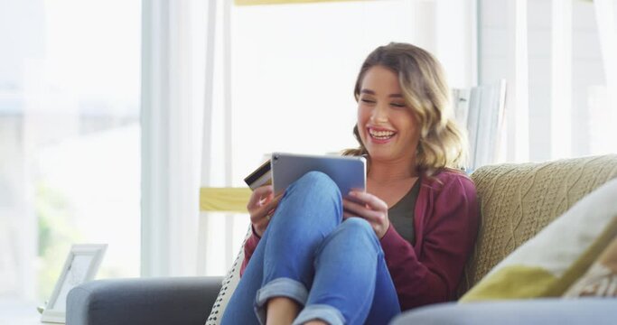 Woman on couch with tablet, credit card and laughing at social media promo for online shopping in apartment. Happiness, relax and excited girl on sofa, website for ecommerce payment or bonus cashback