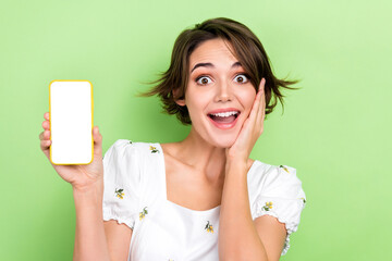 Photo of funky shocked lady wear white blouse reading news modern device empty space isolated green color background