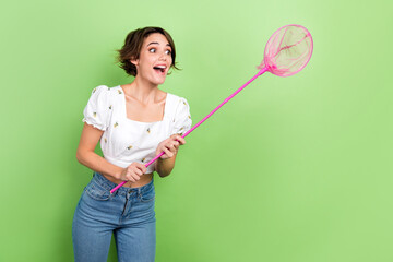 Photo of cute impressed woman dressed white top catching butterflies empty space isolated green color background
