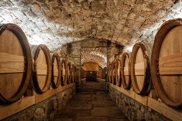 Wine cellar with row of wine barrels