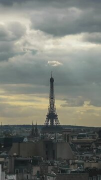 Vertical timelapse of clouds piling up over the Paris as the evening comes. Panoramic shot of the city with the Eiffel Tower in centre