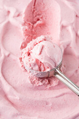 Strawberry ice cream with spoon. Ice cream food background. Close up, top view.