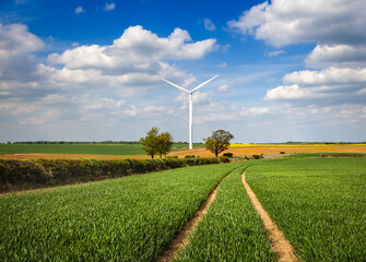 Agricultural landscape with wind turbine - 610992379