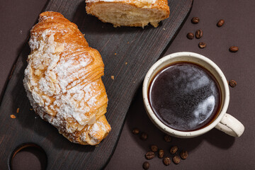 Good morning concept. Breakfast with cup of coffee and fresh croissant. Sweet creamy sauce