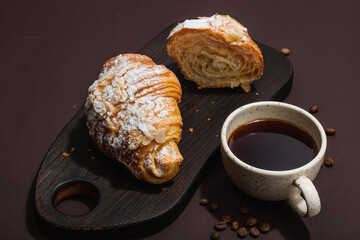 Good morning concept. Breakfast with cup of coffee and fresh croissant. Sweet creamy sauce
