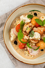 Portion of gourmet dish with ptitim and seafood