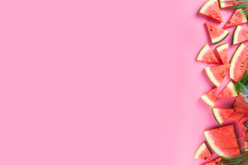 Watermelon slices arranged on high-colored pink background. Simple basic summer harvest and holiday...