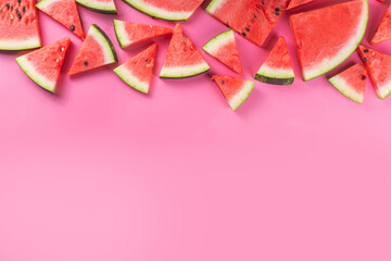 Watermelon slices arranged on high-colored pink background. Simple basic summer harvest and holiday...