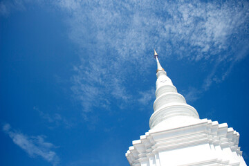 White pagoda on blue sky with white cloud background